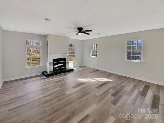 unfurnished living room with ceiling fan and light hardwood / wood-style floors