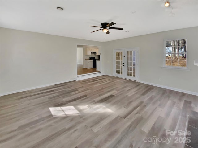 unfurnished living room with light hardwood / wood-style floors, french doors, and ceiling fan