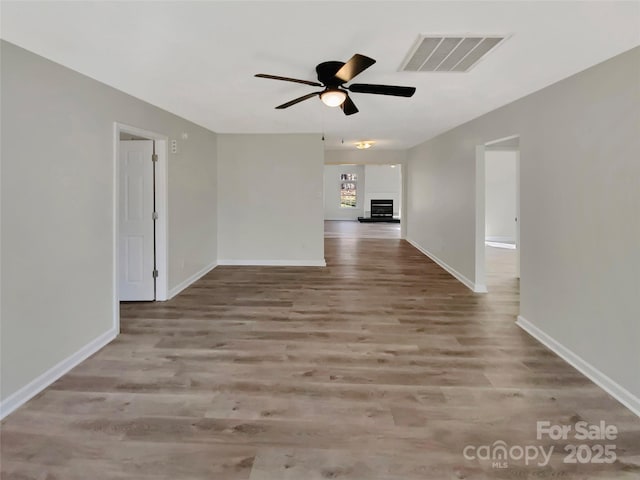 spare room featuring ceiling fan and light wood-type flooring