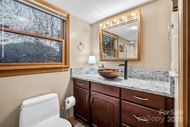 bathroom featuring vanity and toilet