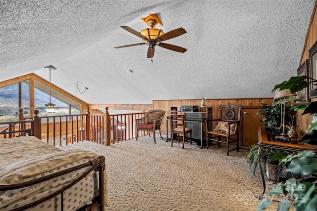 bedroom featuring carpet floors, vaulted ceiling, a textured ceiling, and wood walls