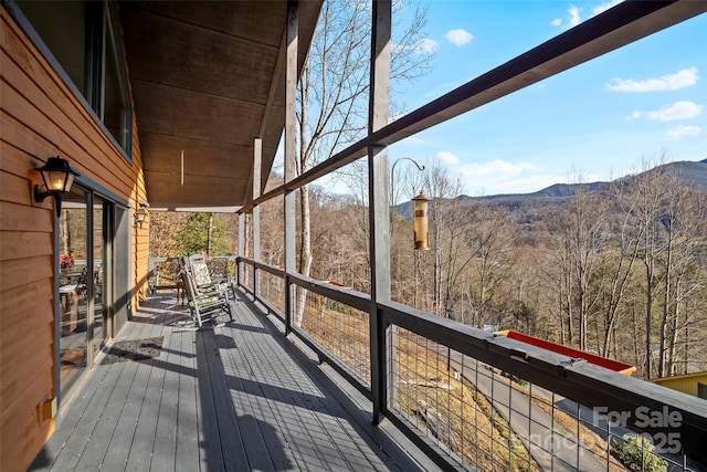 wooden deck with a mountain view