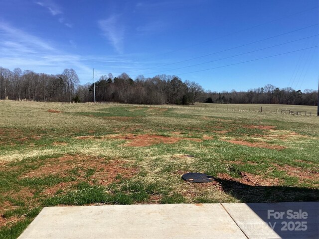 view of yard with a rural view