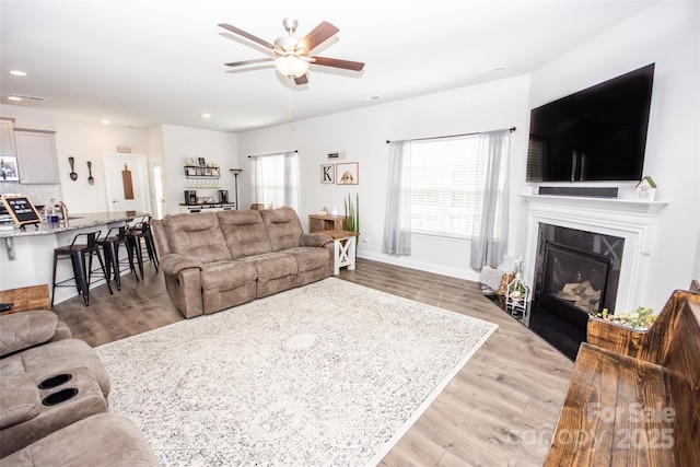 137 Tenth Green Ct, Statesville, NC 28677 - living room with ceiling fan, recessed lighting, light wood-style flooring, and a fireplace