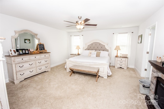 137 Tenth Green Ct, Statesville, NC 28677 - bedroom with multiple windows, light carpet, a stone fireplace, and baseboards