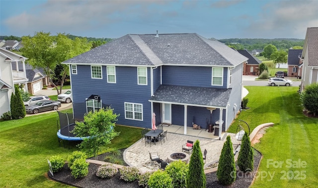 137 Tenth Green Ct, Statesville, NC 28677 - back of house featuring a fire pit, roof with shingles, a patio area, and a yard