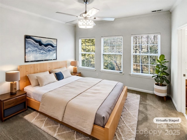 carpeted bedroom with ceiling fan and crown molding