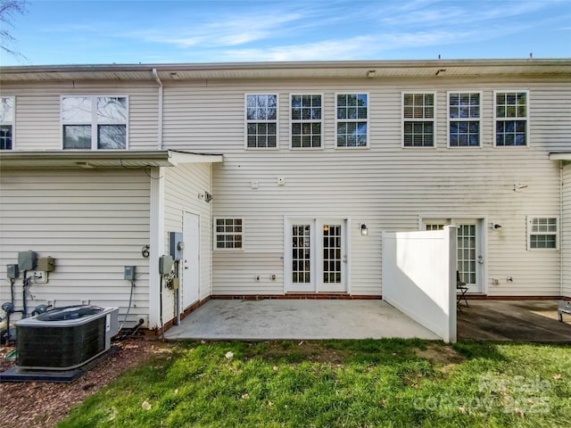 back of property featuring a patio, cooling unit, and a lawn