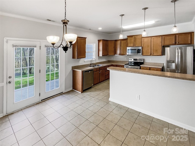 kitchen featuring appliances with stainless steel finishes, sink, ornamental molding, and decorative light fixtures