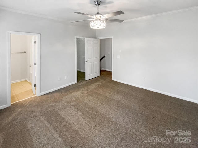 unfurnished bedroom with ornamental molding, carpet flooring, connected bathroom, and a spacious closet