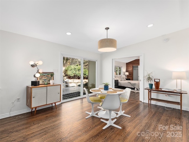 dining room with baseboards, wood finished floors, and recessed lighting