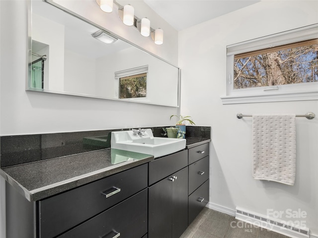 bathroom with visible vents, vanity, and baseboards