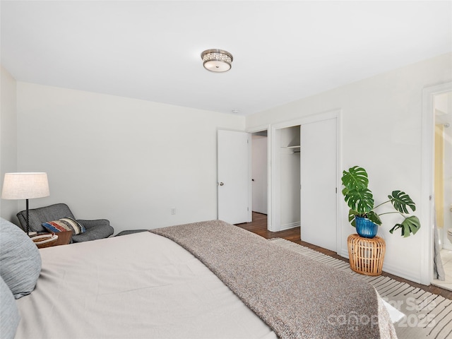 bedroom with a closet and wood finished floors