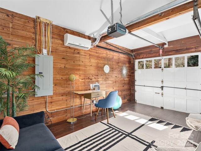 garage featuring a garage door opener, an AC wall unit, electric panel, and wooden walls