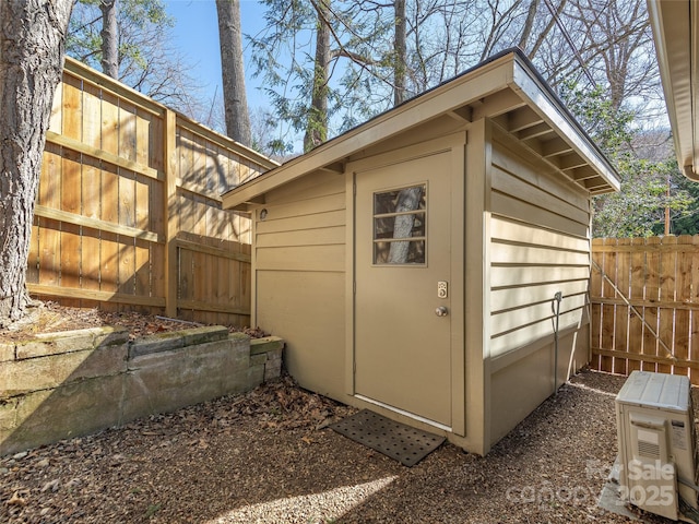 view of shed with fence