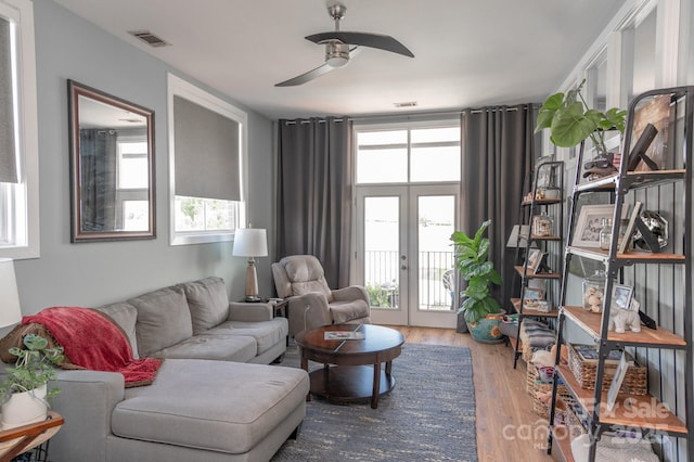 living room with french doors, ceiling fan, wood-type flooring, and a wealth of natural light