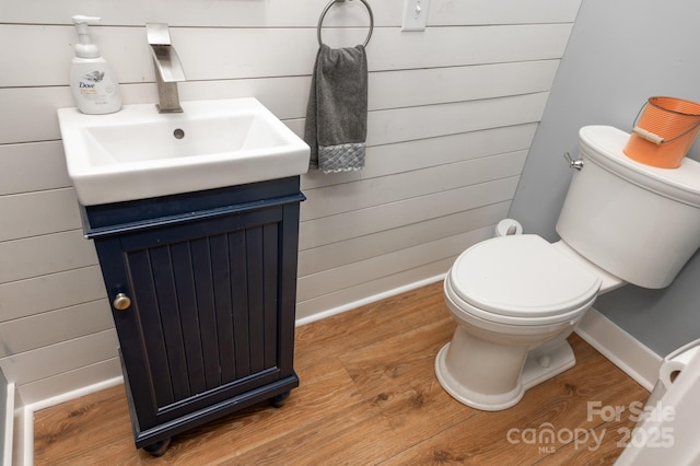 bathroom featuring hardwood / wood-style flooring, vanity, and toilet