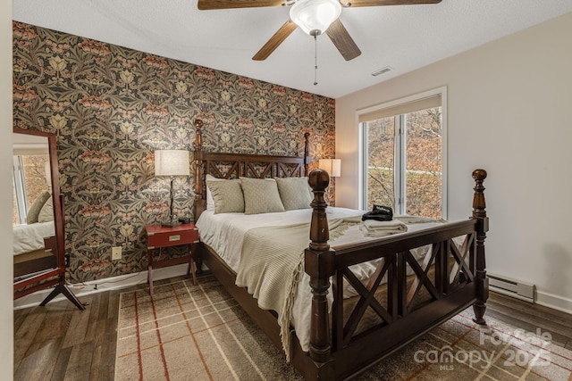 bedroom with wallpapered walls, baseboards, visible vents, and wood finished floors