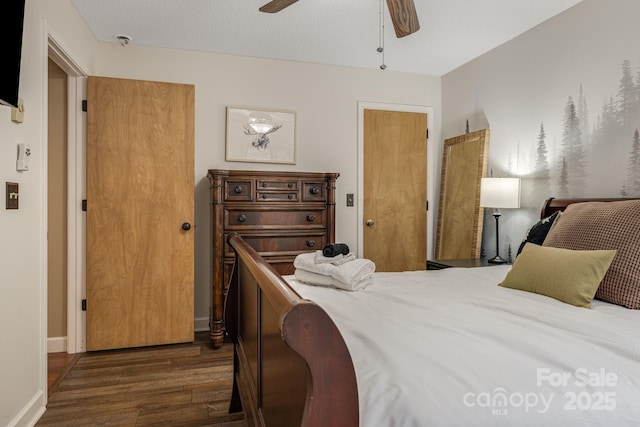 bedroom featuring ceiling fan, dark wood-type flooring, and baseboards