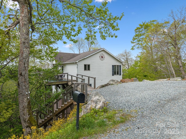 114 Spruce Hollow Rd, Beech Mountain, NC 28604 - view of home's exterior with stairway, a wooden deck, and roof with shingles