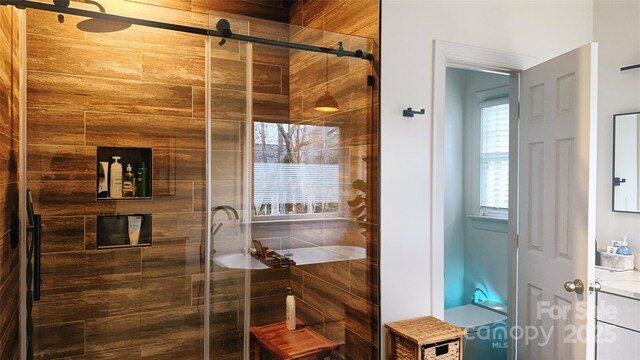 bathroom featuring a shower with door