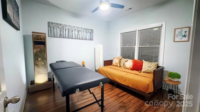 sitting room featuring dark hardwood / wood-style floors and ceiling fan