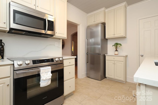 kitchen with crown molding, stainless steel appliances, and backsplash