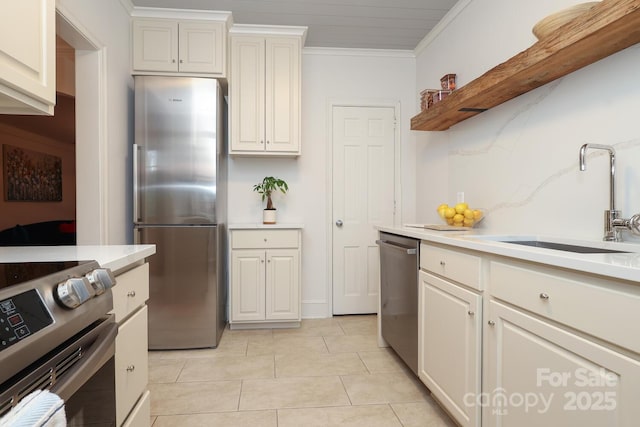 kitchen featuring ornamental molding, stainless steel appliances, sink, and light tile patterned floors