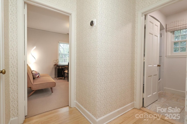 hallway with hardwood / wood-style flooring