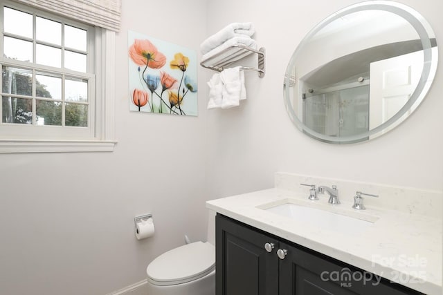 bathroom with vanity, toilet, and walk in shower