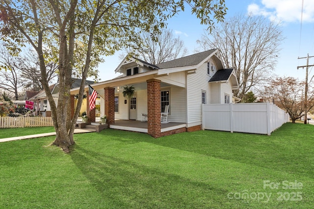 view of front of property with fence and a front lawn