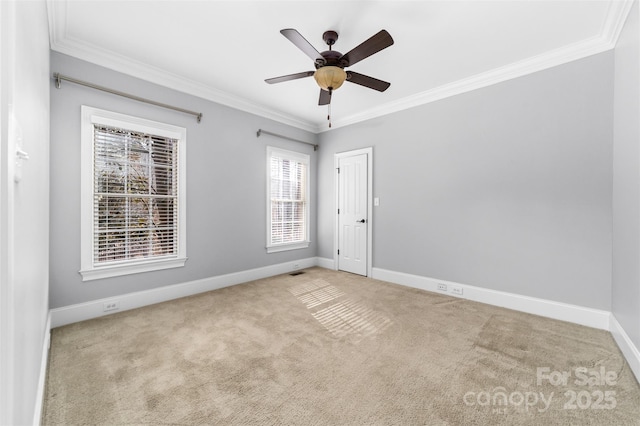 unfurnished room featuring light carpet, ornamental molding, and ceiling fan