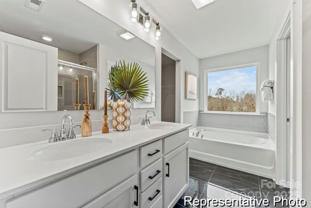 bathroom featuring vanity and shower with separate bathtub