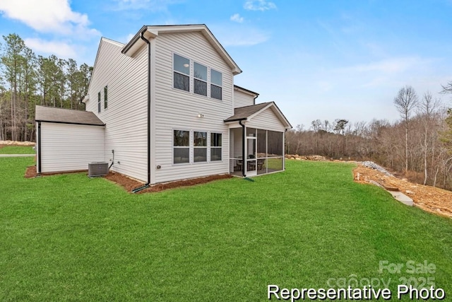 rear view of house featuring cooling unit, a lawn, and a sunroom