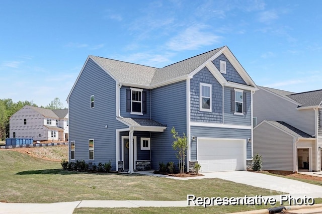 view of front of home with a garage, driveway, and a front yard