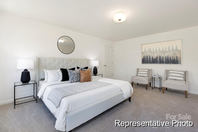 bedroom featuring baseboards and light carpet