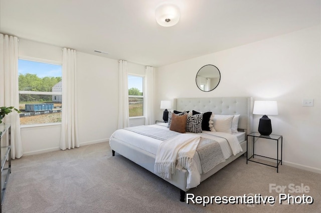 bedroom with carpet flooring and baseboards