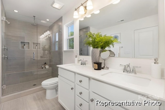 full bath with toilet, visible vents, a sink, and a stall shower