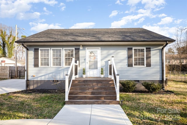 bungalow-style house featuring a front lawn