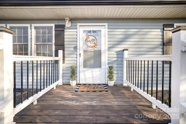 view of exterior entry with a deck