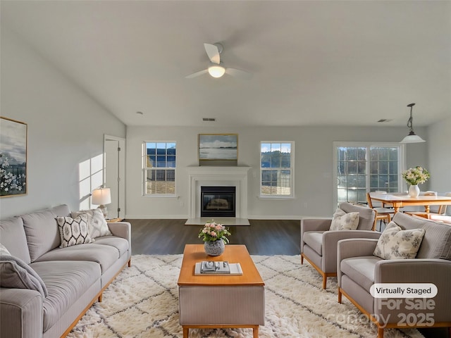 living room with wood-type flooring and ceiling fan