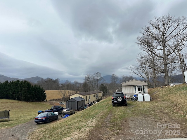 view of street featuring a mountain view and driveway