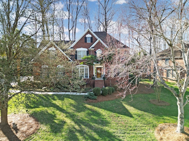 view of front of property with brick siding and a front yard