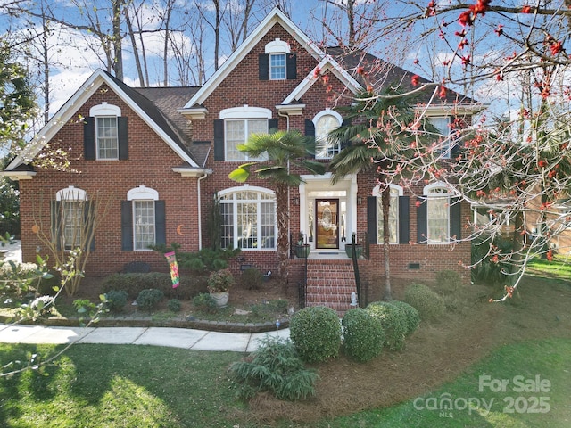 traditional-style home with brick siding