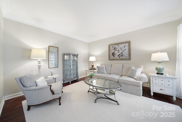 living room featuring ornamental molding, baseboards, and wood finished floors