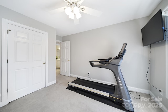 workout area featuring carpet floors, ceiling fan, and baseboards