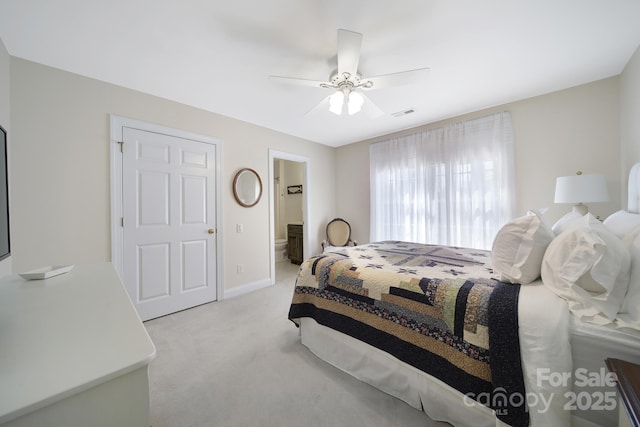 bedroom featuring light carpet, a ceiling fan, and baseboards