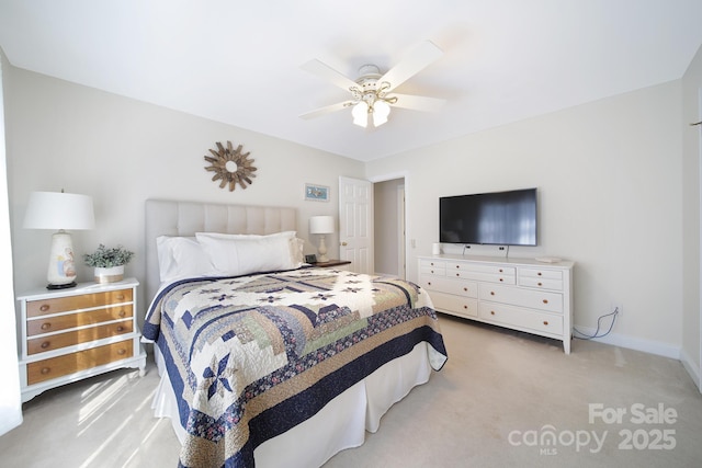 bedroom with light carpet, ceiling fan, and baseboards