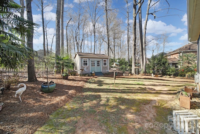 view of yard featuring fence and an outdoor structure