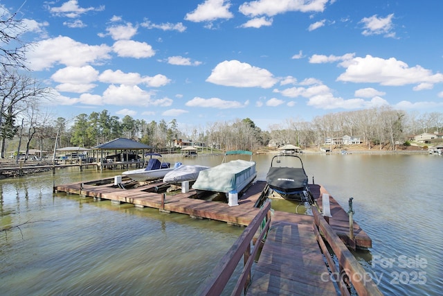 dock area with a water view and boat lift